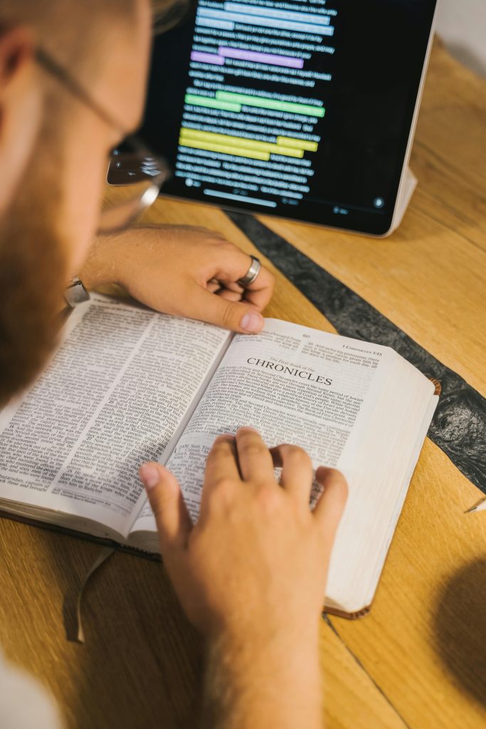pexels-photo-5206039-5206039 An open Bible with Chronicles being studied, accompanied by a digital tablet for reference.